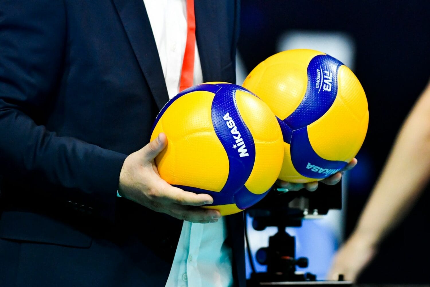 a person holding a blue and yellow ball