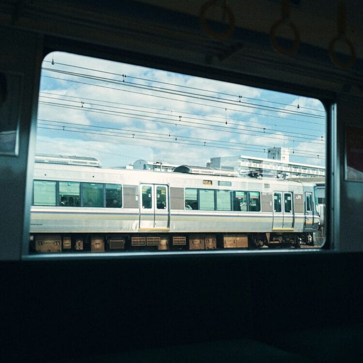 A train is viewed through a window.