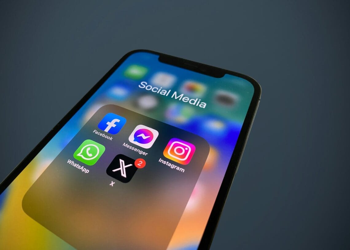a close up of a cell phone with social media icons