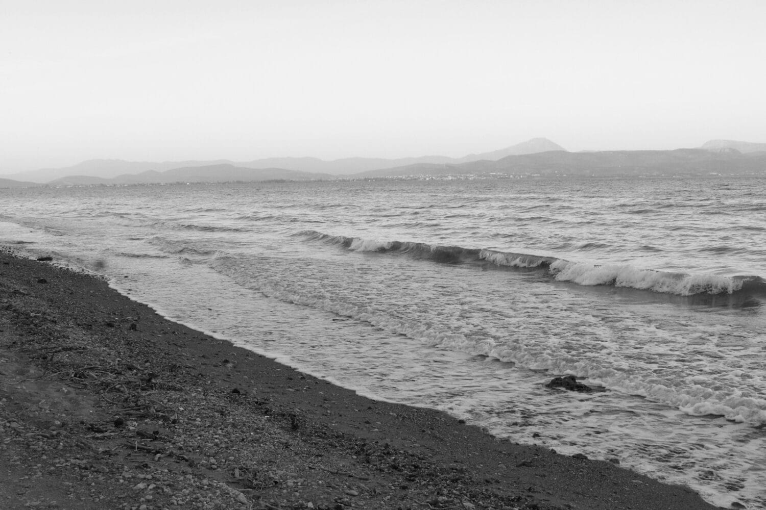 a black and white photo of a beach