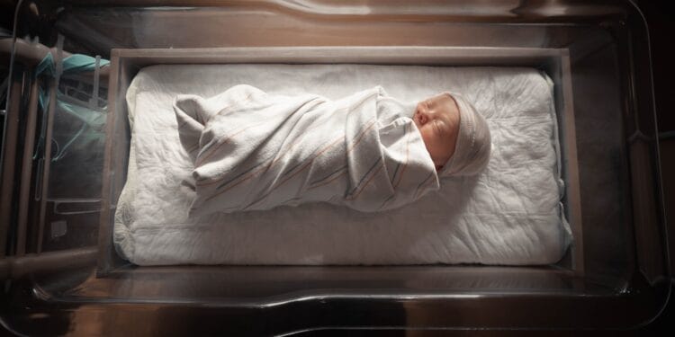 woman in white long sleeve shirt lying on bed