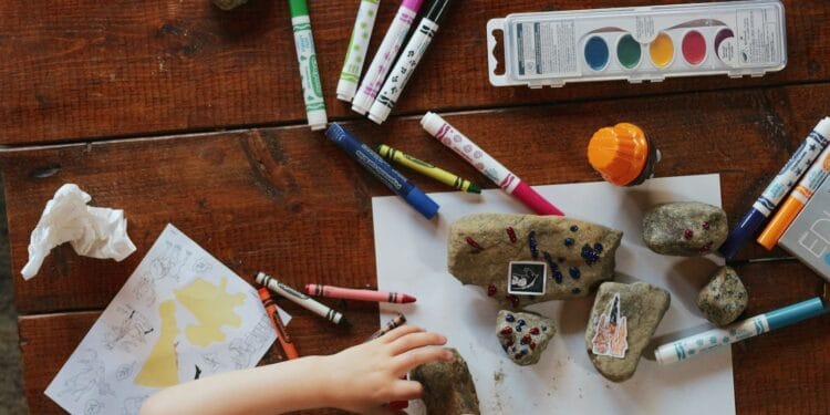 person holding white and gray stone