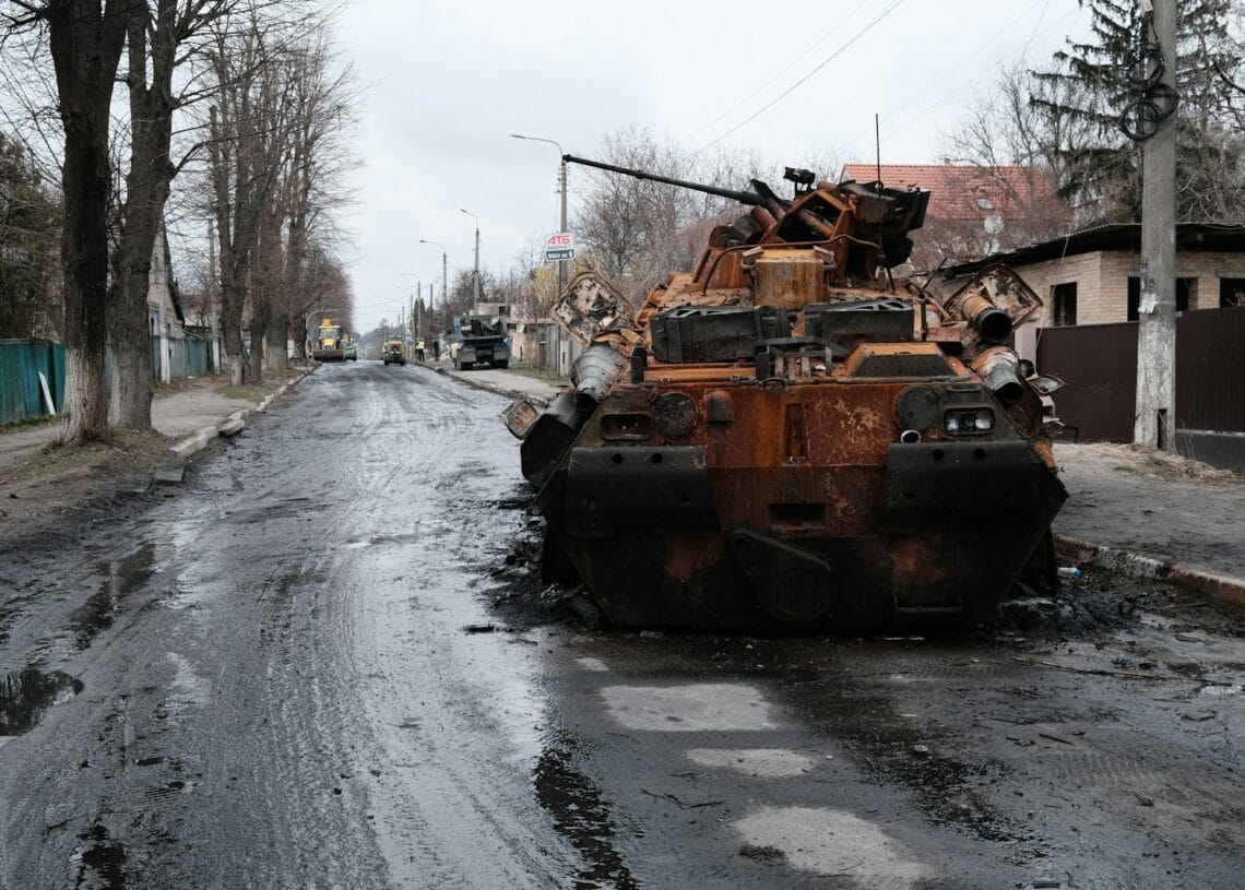 a large rusted out tank sitting on the side of a road