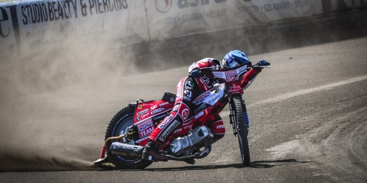 a man riding a motorcycle on top of a race track